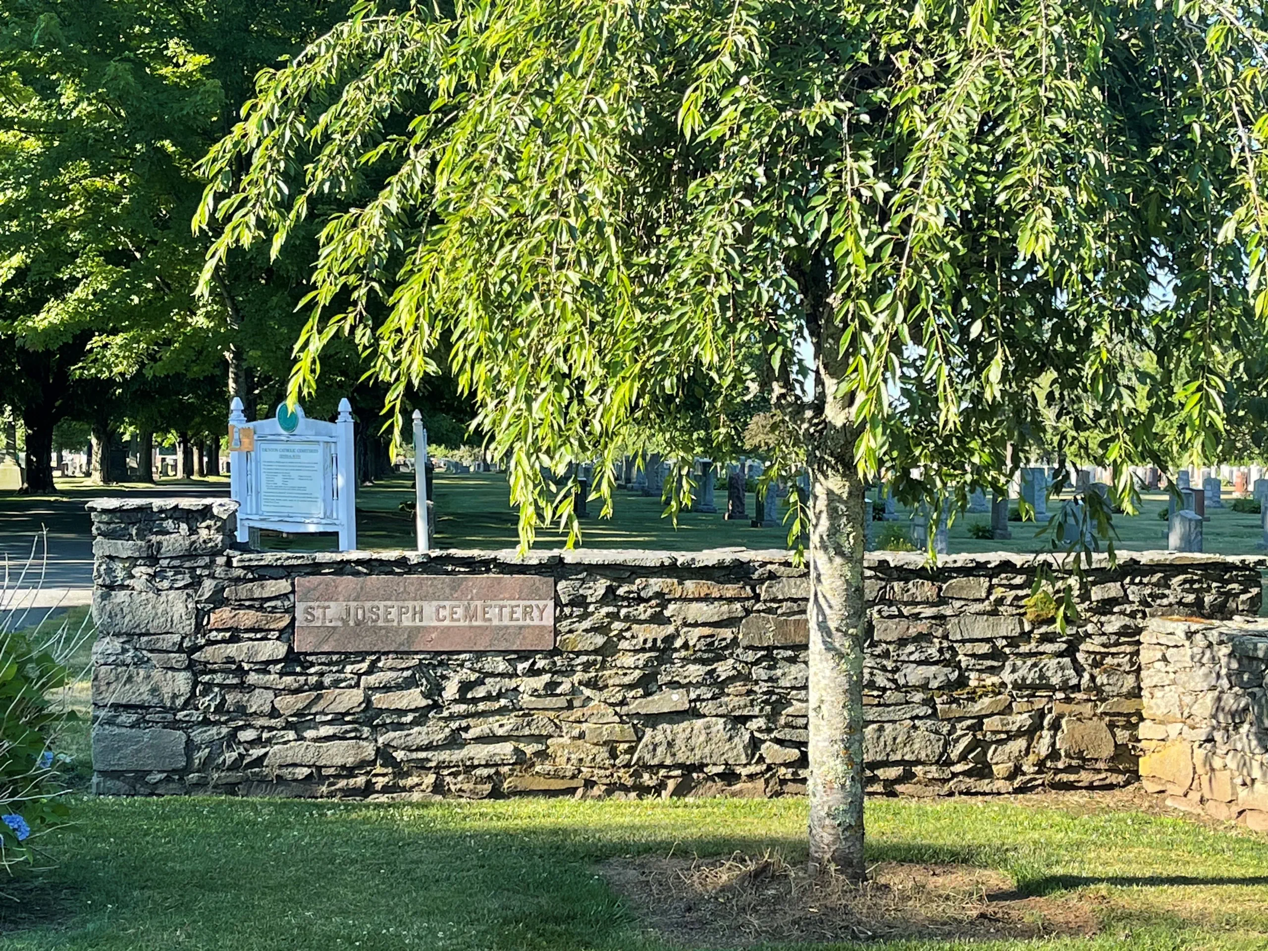Stone cemetery wall of St. Joseph Cemetery in Taunton
